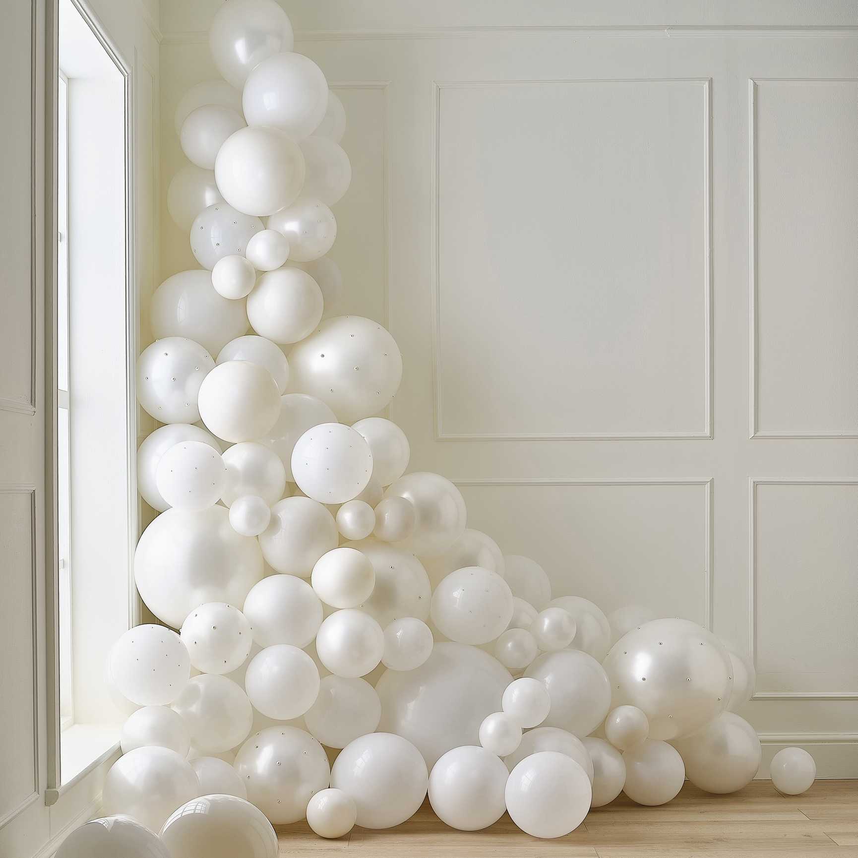 white and cream balloon arch with pearls elegant party decoration