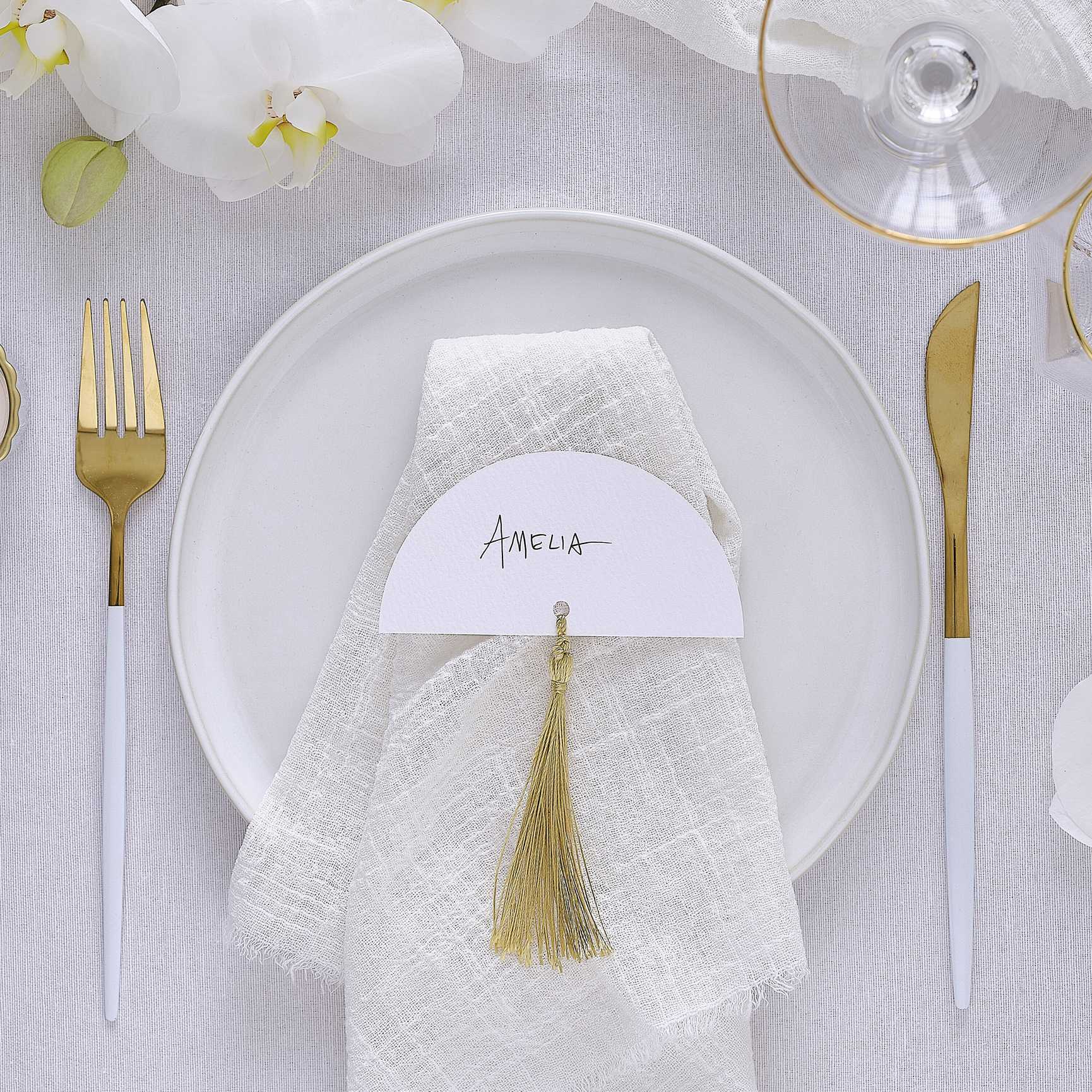 white wedding place cards with gold tassels elegant table décor