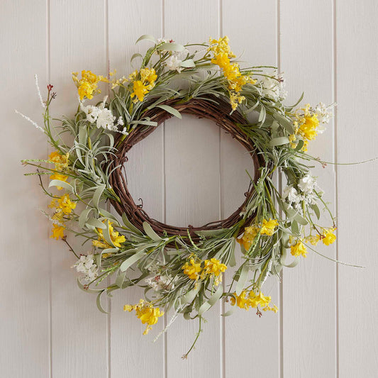 yellow artificial flower spring wreath hanging on a front door