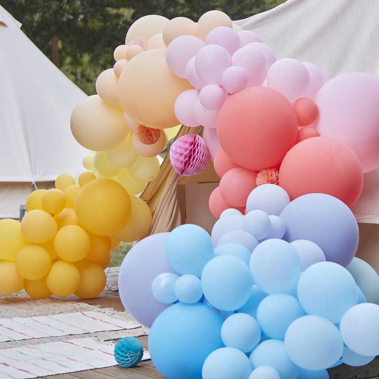 Colourful balloon arch kit bright balloons and paper fans backdrop