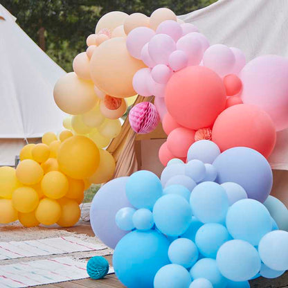 Colourful balloon arch kit bright balloons and paper fans backdrop