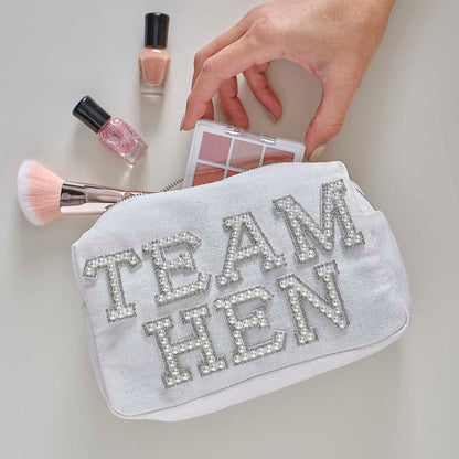 white pearl-embellished “Team Hen” makeup bag for hen party