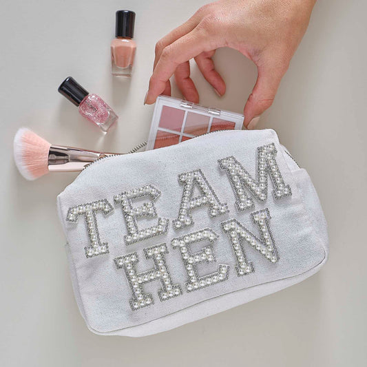 white pearl-embellished “Team Hen” makeup bag for hen party